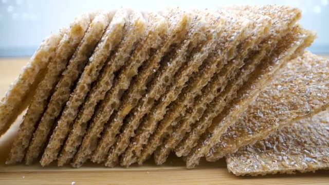 The crispy breads lined up on the wooden table 