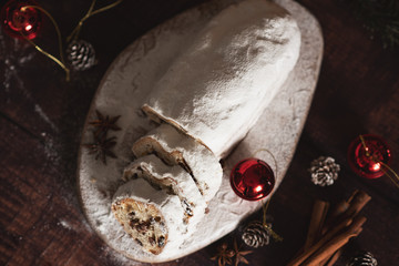 Traditional German Christmas cake - Cranberry Stollen, Christmas tree, ornaments, and candles.