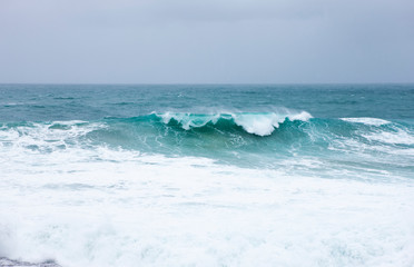 Foamy strong waves crashing in the ocean