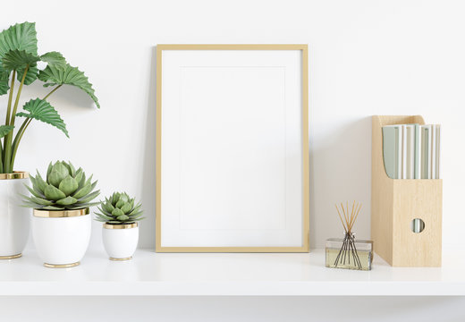 Golden frame leaning on white shelve in interior with plants and books mockup 3D rendering