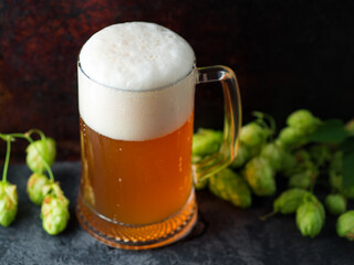 close-up of a mug of unfiltered wheat beer and green hops