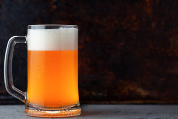 Glass mug of wheat unfiltered beer on a rusty background copy space