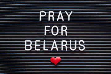 words Pray for Belarus on blue background