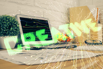 Desktop computer background in office and start up theme hologram drawing. Double exposure. Startup...