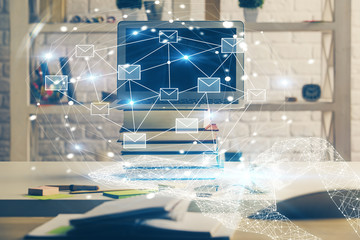 Desktop computer background in office and flying envelops hologram drawing. Double exposure. Electronic mail concept.