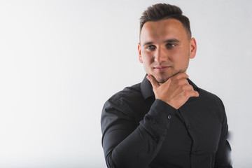 portrait of a young, handsome, round-faced man in a black shirt isolated on a white background, there is room for text