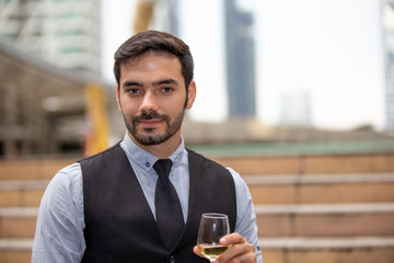 portrait of young man holding wine glass