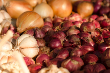 Garlic, Onion And Spices on wooden background. Selective focus.