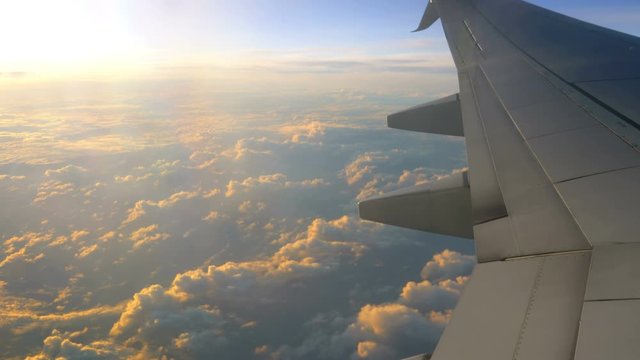 Airplane Wing With A view On Clouds And Blue Sky in 4K