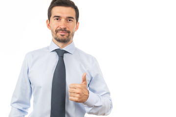 Smiling  young man in blue shirt and tie showing thumbs up gesture