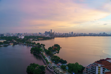 Obraz premium Hanoi cityscape with skyline view during sunset period at West Lake ( Ho Tay ) in 2020