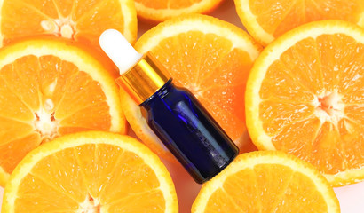 Close up the Bottle of essential oil from oranges which Dropping serum collagen moisturizer orange of essential oil