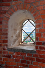 Window niche on a brick wall in a tower
