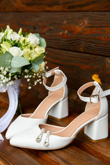 Wedding details. Shoes and a bouquet of the bride