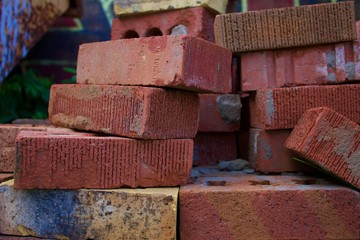 A pile of standard modular bricks from an industrial yard.
