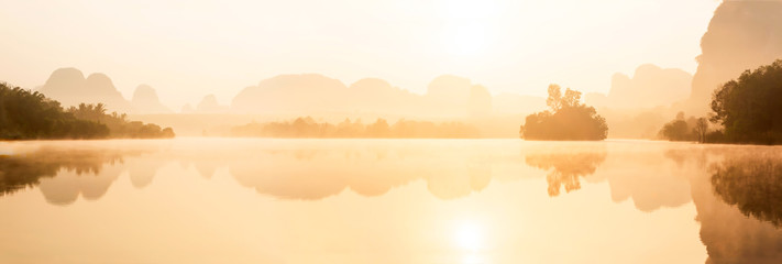 Naklejka na ściany i meble Panoramic scenery of tropical lake at sunrise.