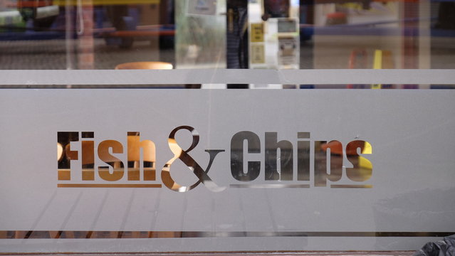 Fish and chip sign etched onto a class window.