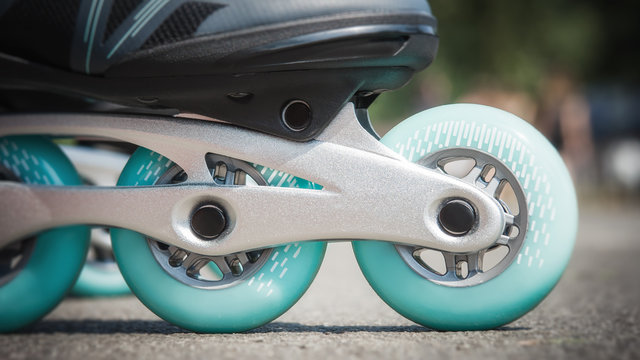 Close up of inline roller skates with blue wheels. Extreme sport. Concept about sport and leisure. Sport lifestyle. Fun time activity