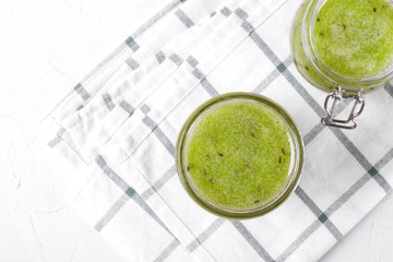 Green jam in a glass jar. Top view