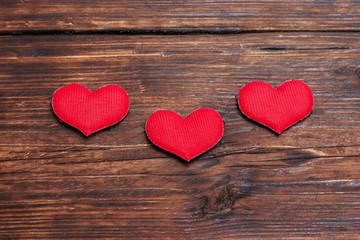 Red hearts on a dark wooden background