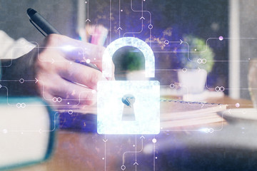 Double exposure of woman's hands writing with lock icon. Concept of security and protection of data