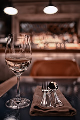 glass white wine restaurant interior, abstract evening dinner with alcohol at the bar