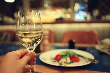 glass white wine restaurant interior, abstract evening dinner with alcohol at the bar
