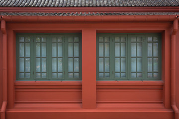 Antique green wooden window with red old building and ancient brown roof tiles interior exterior architecture