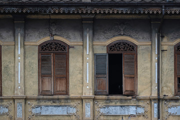 Beautiful ancient wooden stencil engraving windows and stucco pattern with and old yellow historical building exterior architecture