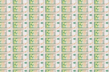 10 Sri Lankan rupees bills printed in money production conveyor. Collage of many bills. Concept of...