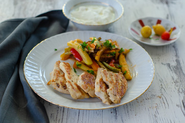 Grilled chicken and vegetables on the white plate.Healthy eating and dieting concept.