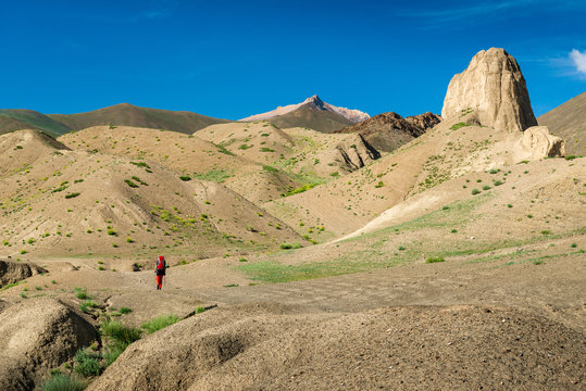 Traveller on the trekking on Markha valley trek route in Ladakh, Karakorum panorama. This region is a purpose of motorcycle expeditions