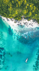 View from the drone on the azure sea with a natural shoreline.
