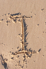 I - Alphabet letter written on sand 