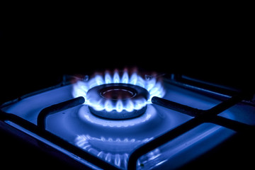 Blue flame from a burner in a gas stove on.