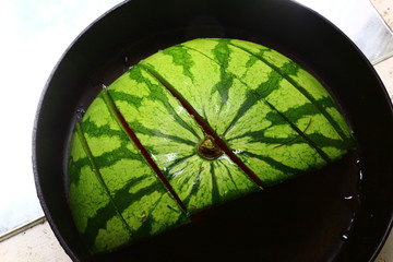Sliced water melon in a cast iron skillet