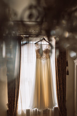 Fototapeta na wymiar wedding dress on the curtain