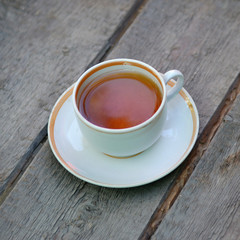 A Cup of tea on a wooden surface for Breakfast. Close up.