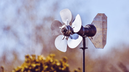 Old hand-made windmill made of pieces of metal sheet.