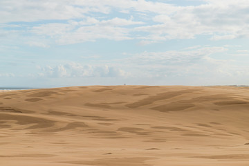 Two people at the distance on the desert.