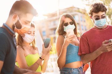 Group of friends wearing protective face mask during coronavirus (COVID-19) pandemic disease and...