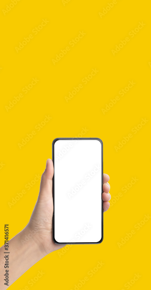 Poster mockup hand holding mobile blank screen on yellow background.mockup banner display of content to advert on media.Clipping path on both hand and smartphone screen