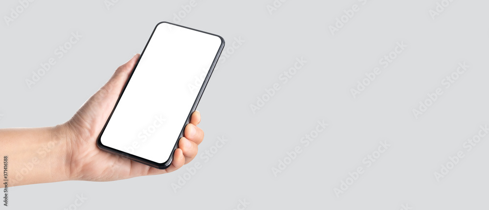 Poster mockup hand holding mobile blank screen on grey background.mockup banner display of content to adver