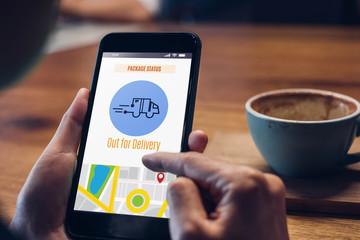 Close up hand checking delivery package tracking with courier with mobile phone app at home.new...