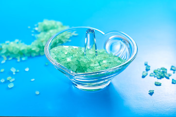 blue sea salt in a glass stand on a white background in a blue frame.