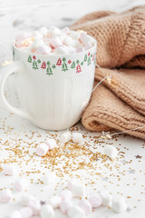 cup with hot chocolate and marshmallows close up on a white background
