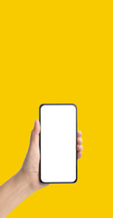mockup hand holding mobile blank screen on yellow background.mockup banner display of content to...