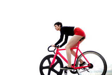 Naklejka premium Portrait of young stylish woman cyclist enjoying fixed gear bike riding outdoors in a cloudy summer day while ride against the sky background with copy space area for your text message or content