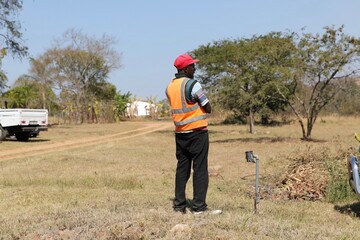 Car guard wearing reflective vest, talking on the mobile phone South Africa 