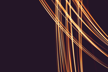 Painting with light at night,  bright orange line shape on a black backgroud. The light source...